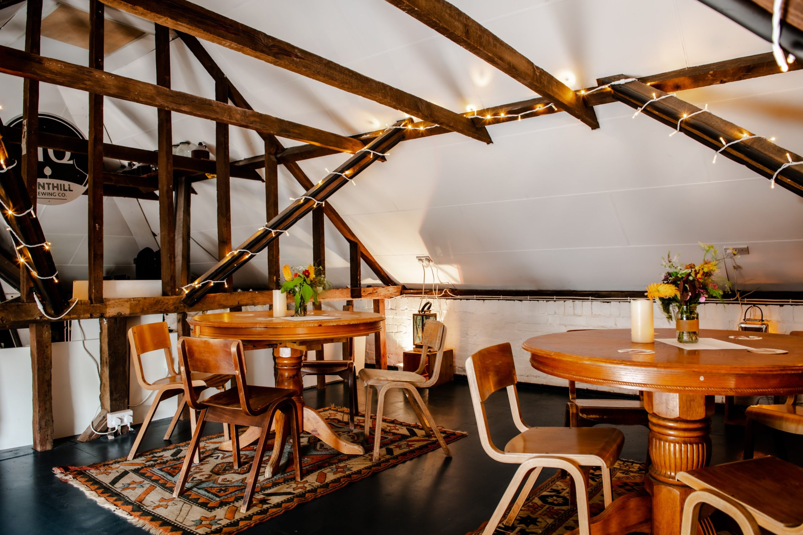 Fonthill Taproom venue hire Tunbridge Wells, round tables, seating, fairy lights, bar.