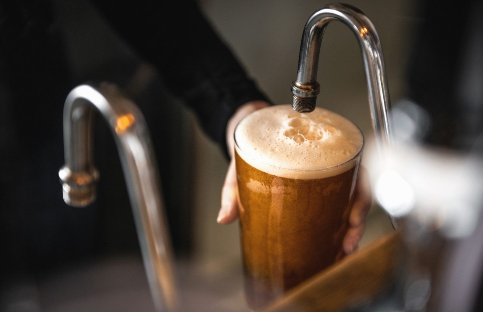 A creamy pint of best bitter being poured from the tap