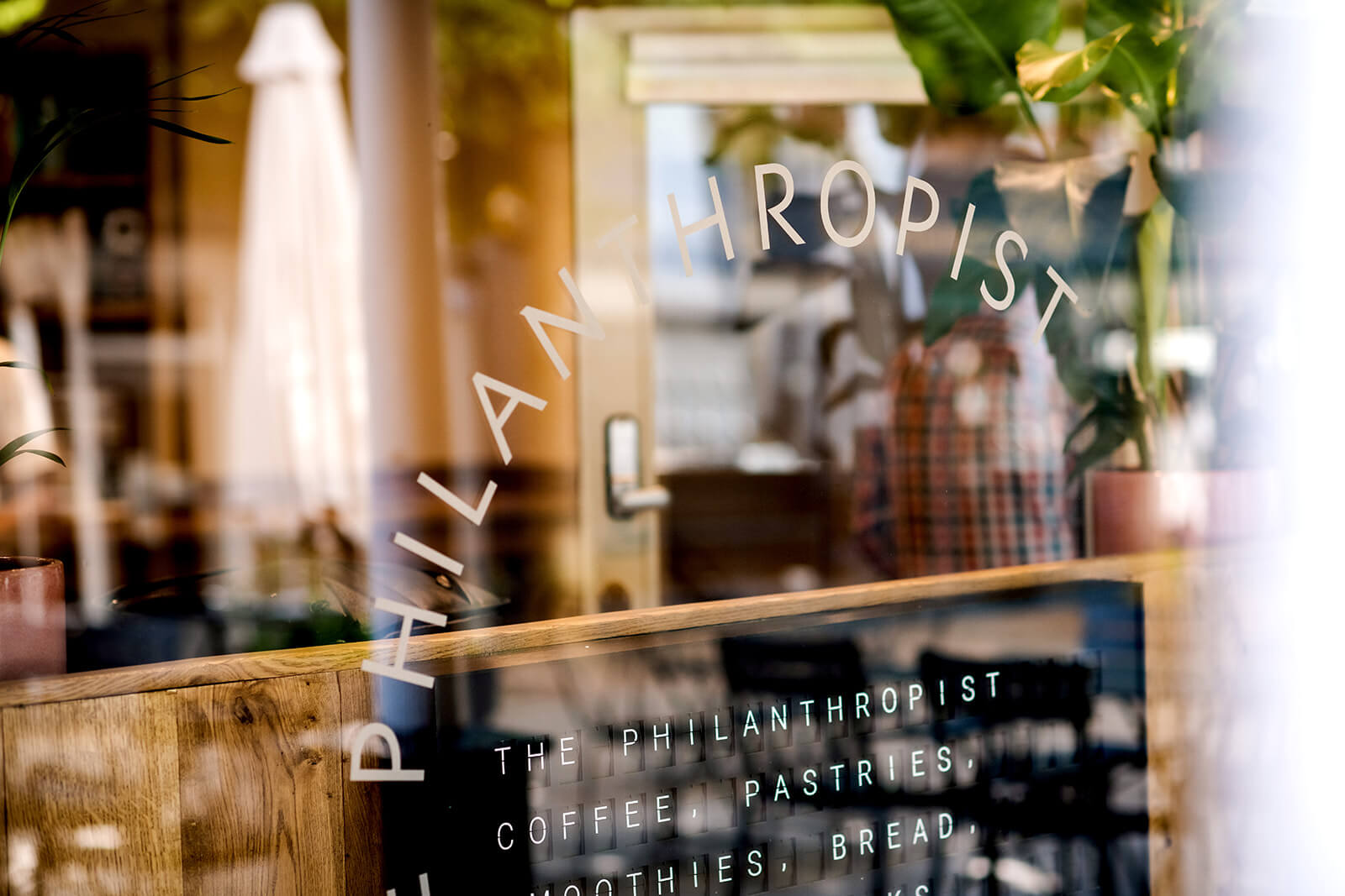 The sign printed on the glass on the exterior of the Philanthropist cafe and bar in tunbridge wells